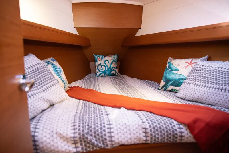 Slide: The Image of Cozy cabin interior of 2020 Jeanneau Sun Odyssey 389 sailboat with nautical-themed bedding. - 9