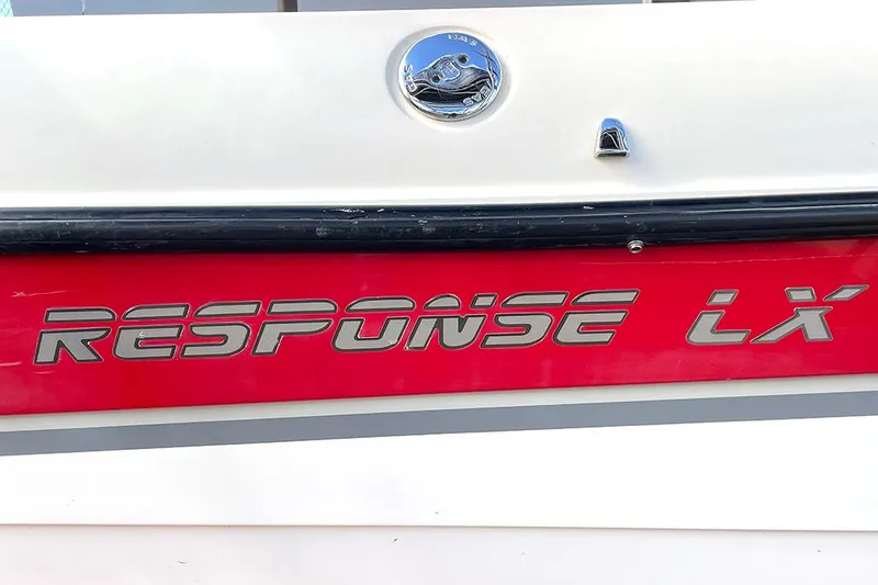 Slide: The Image of 1999 Malibu Response LX boat logo on red and white hull. - 13