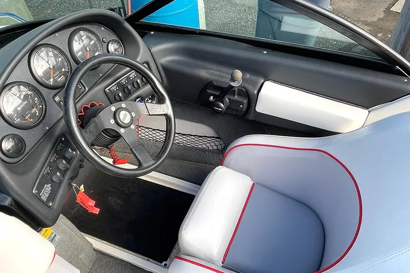 Slide: The Image of 1999 Malibu Response LX boat interior with steering wheel and gauges. - 6