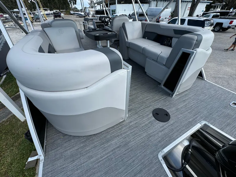 Slide: The Image of 2025 Sweetwater 2286 SB pontoon boat interior with gray seating and carpeted flooring. - 12
