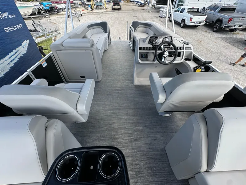 Slide: The Image of 2025 Sweetwater 2286 SB pontoon boat interior with plush seating and modern dashboard. - 14