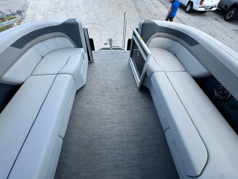 Slide: The Image of 2025 Sweetwater 2286 SB pontoon boat interior with gray seating and carpet flooring. - 16