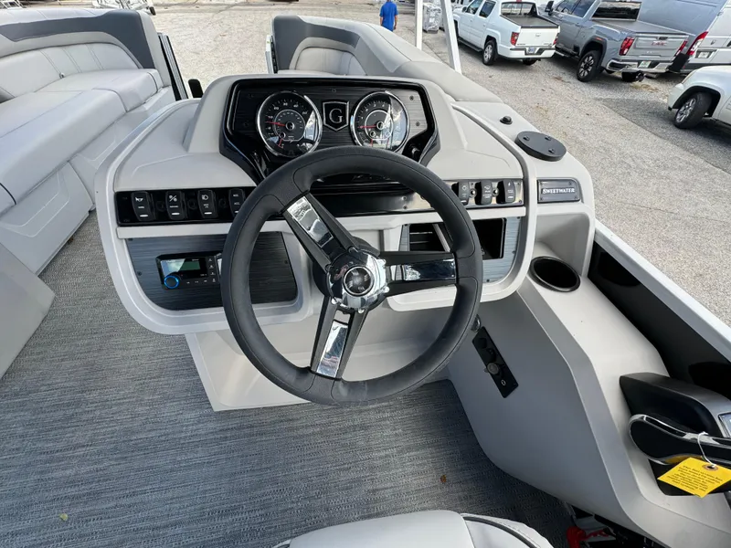 Slide: The Image of 2025 Sweetwater 2286 SB boat dashboard with steering wheel and control panel. - 17