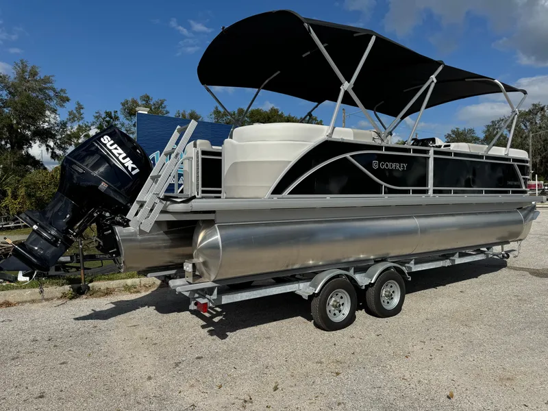 Slide: The Image of 2025 Sweetwater 2286 SB pontoon boat with Suzuki outboard motor on trailer. - 4