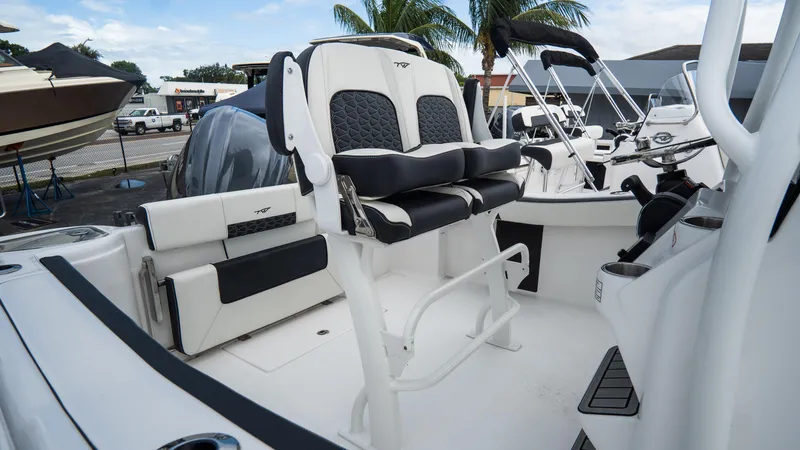 Slide: The Image of 2025 Tidewater 220 CC Adventure boat interior with seating and helm, featuring modern design elements. - 6