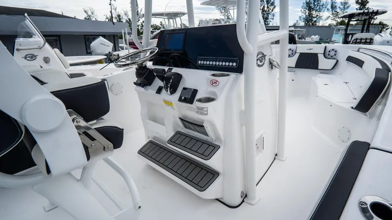 Slide: The Image of 2025 Tidewater 220 CC Adventure boat interior with modern helm and seating. - 7