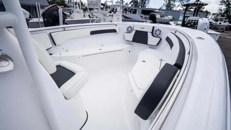 Slide: The Image of 2025 Tidewater 220 CC Adventure boat interior with cushioned seating and speakers. - 9