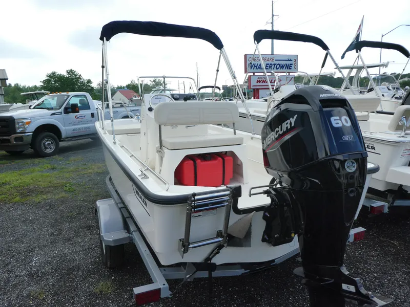 Slide: The Image of 2025 Boston Whaler 150 Montauk boat with Mercury 60 engine on trailer. - 2