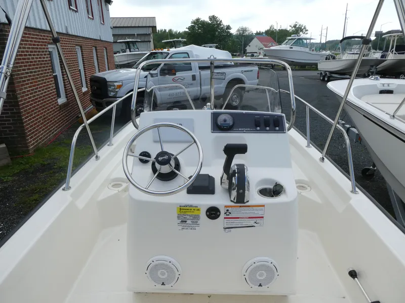 Slide: The Image of 2025 Boston Whaler 150 Montauk boat interior with steering console and controls. - 3