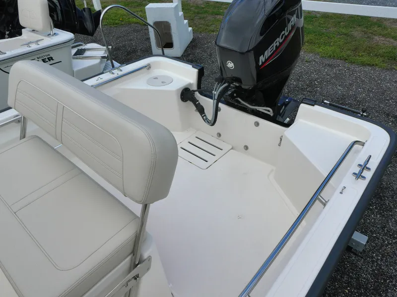Slide: The Image of 2025 Boston Whaler 150 Montauk boat with Mercury engine, featuring spacious seating and clean design. - 4