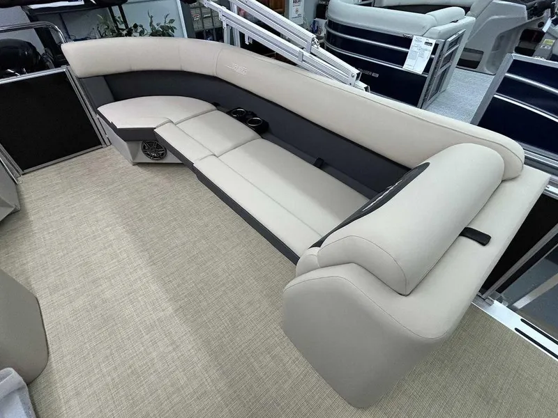 Slide: The Image of 2025 Harris Cruiser 210 boat interior with beige seating and cup holders. - 10