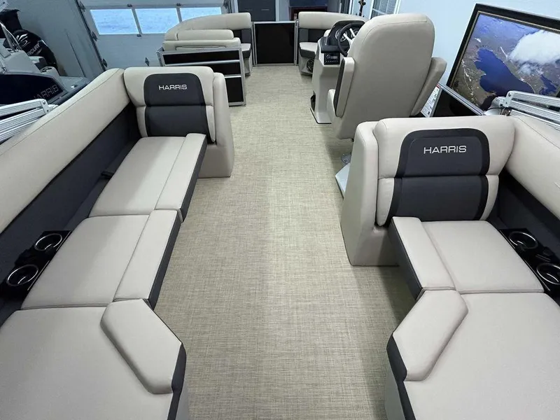 Slide: The Image of 2025 Harris Cruiser 210 interior with beige seating and modern design. - 11