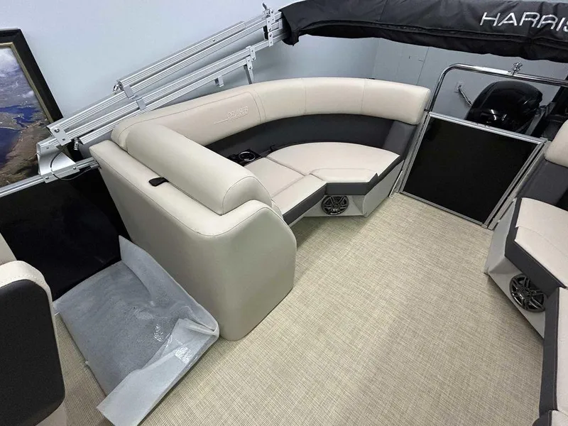 Slide: The Image of 2025 Harris Cruiser 210 boat interior with beige seating and modern design. - 12