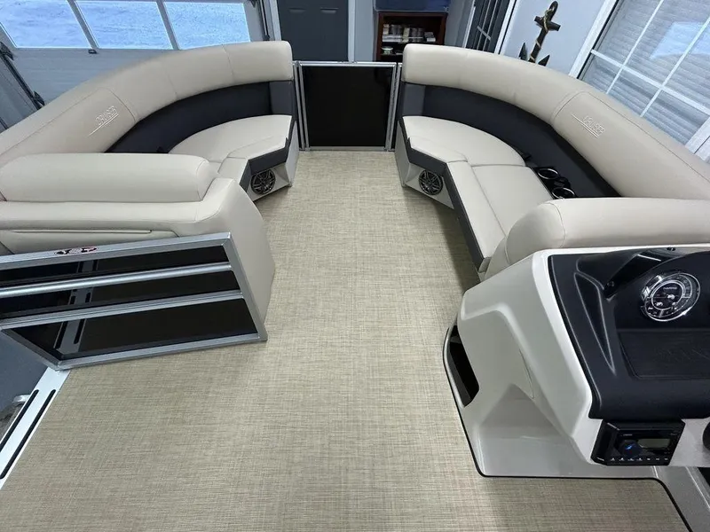 Slide: The Image of 2025 Harris Cruiser 210 interior with beige seating and modern design. - 2