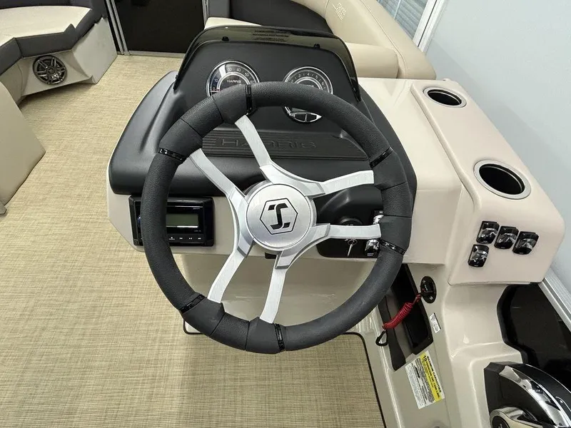 Slide: The Image of 2025 Harris Cruiser 210 steering wheel and dashboard interior view. - 3