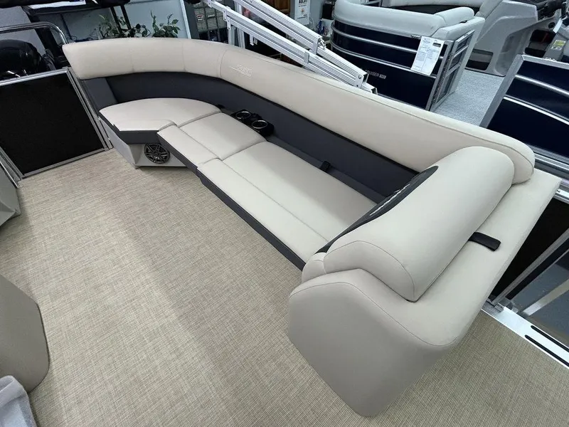 Slide: The Image of 2025 Harris Cruiser 210 boat interior with beige seating and carpet flooring. - 5