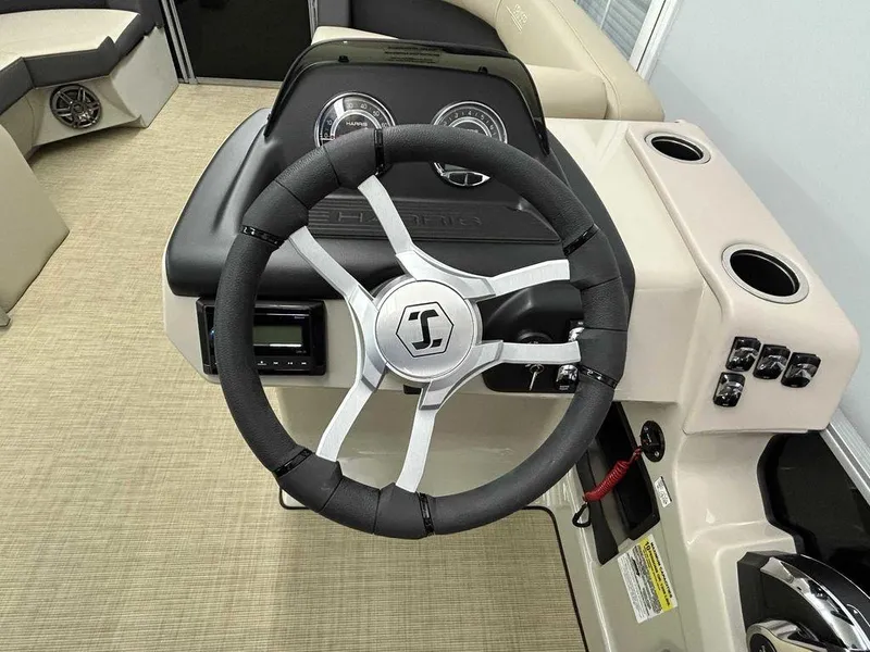 Slide: The Image of 2025 Harris Cruiser 210 steering wheel and dashboard interior. - 8