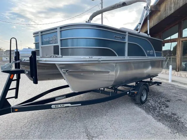 Slide: The Image of 2023 SunCatcher Select 16F pontoon boat on trailer, parked outdoors. - 3