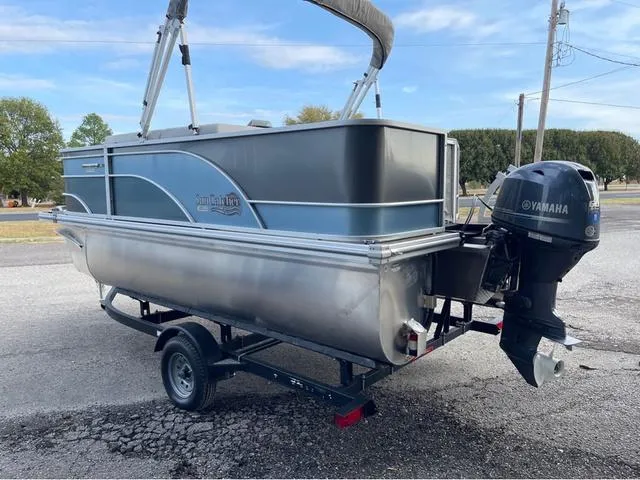 Slide: The Image of 2023 SunCatcher Select 16F pontoon boat with Yamaha outboard motor on trailer. - 4