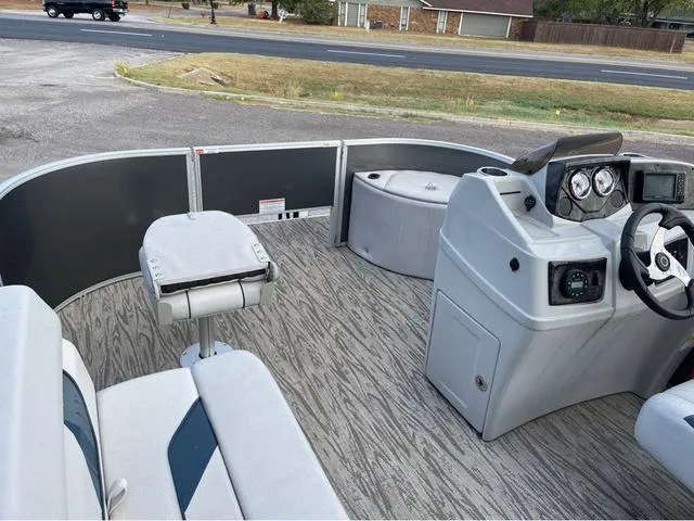 Slide: The Image of 2023 SunCatcher Select 16F pontoon boat interior with steering console and seating. - 6