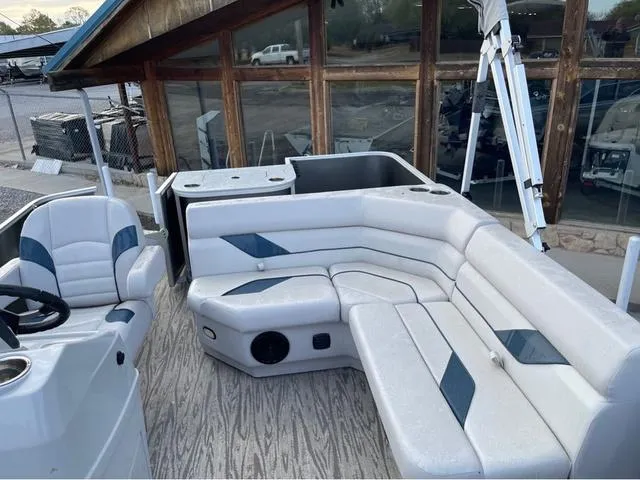 Slide: The Image of 2023 SunCatcher Select 16F pontoon boat interior with plush seating and modern design. - 7
