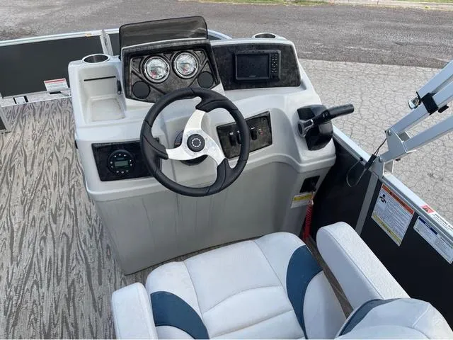 Slide: The Image of 2023 SunCatcher Select 16F boat dashboard with steering wheel and controls. - 9