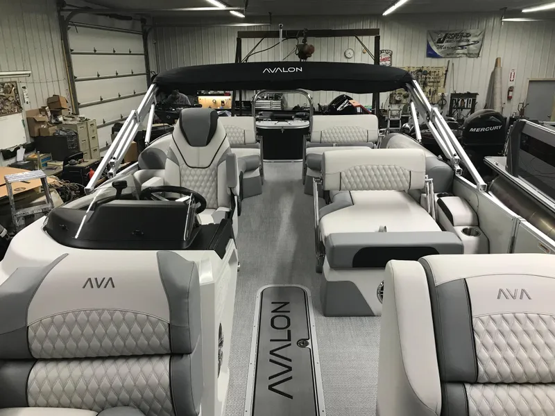 Slide: The Image of 2025 Avalon Catalina boat interior with luxurious seating and modern design in a showroom. - 17