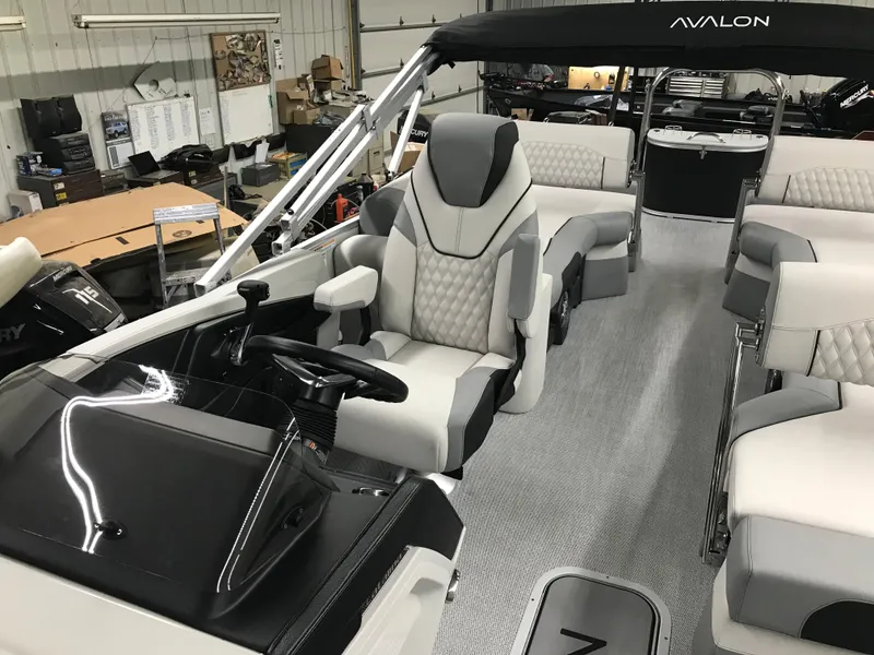 Slide: The Image of 2025 Avalon Catalina boat interior with luxurious seating and modern design in a showroom. - 18