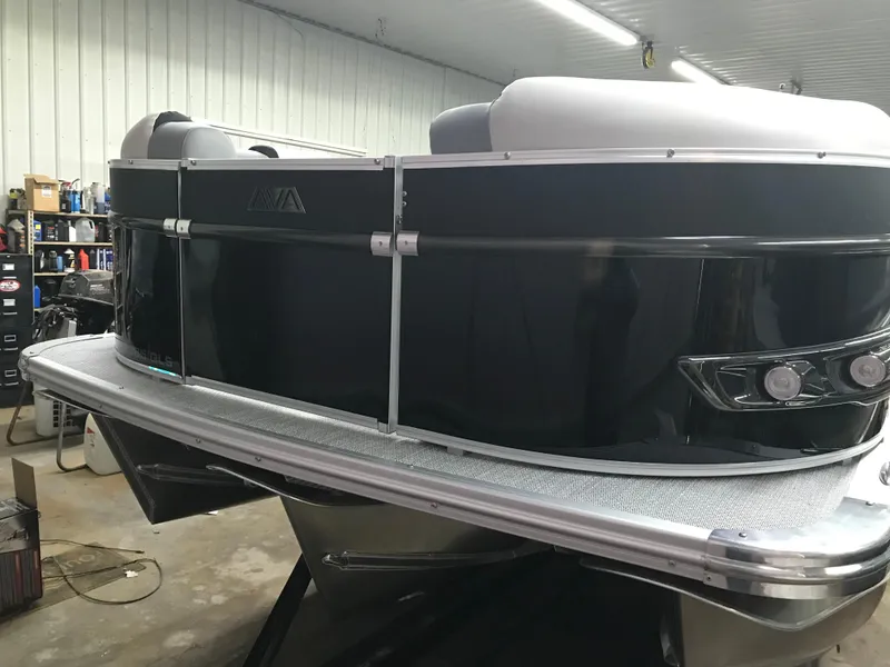 Slide: The Image of 2025 Avalon Catalina pontoon boat in a garage, showcasing sleek black exterior design. - 3