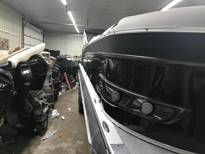 Slide: The Image of 2025 Avalon Catalina boat in a garage with Mercury outboard motors. - 4