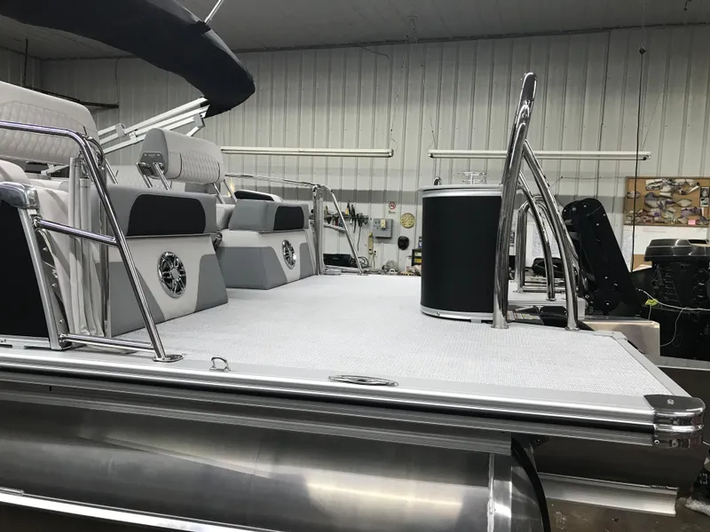 Slide: The Image of 2025 Avalon Catalina boat interior with sleek seating and modern design in a showroom. - 8