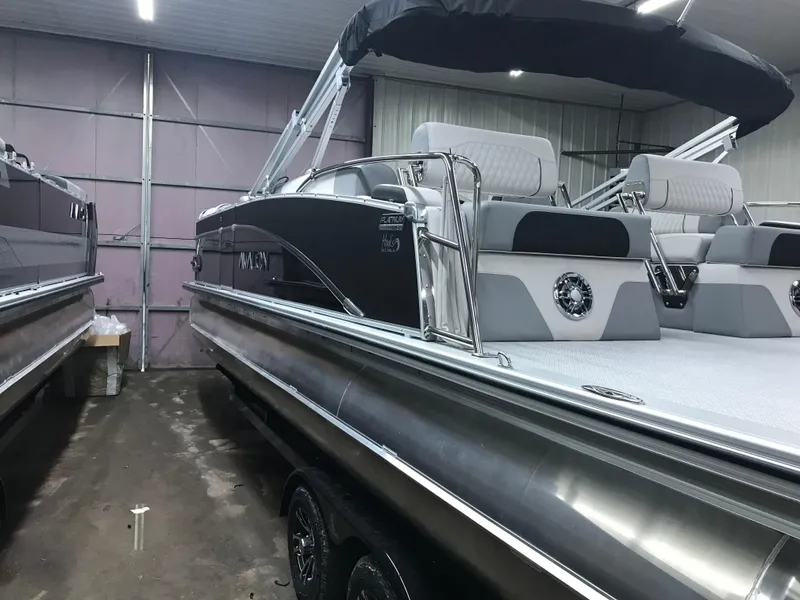 Slide: The Image of 2025 Avalon Catalina pontoon boat in a showroom, featuring sleek design and comfortable seating. - 9