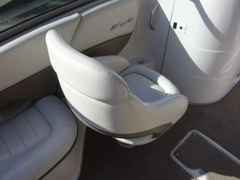 Slide: The Image of 2002 Four Winns 234 Funship boat interior with white seating and cup holder. - 19