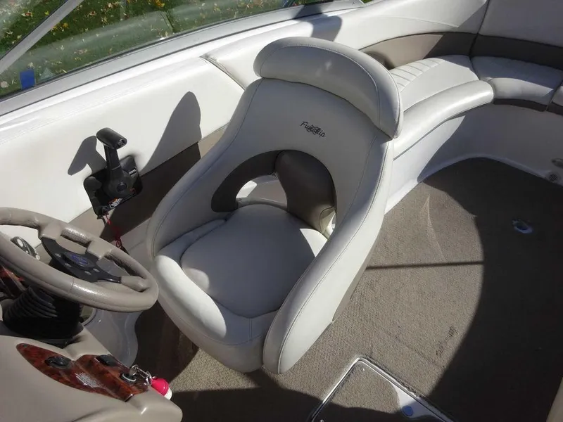 Slide: The Image of 2002 Four Winns 234 Funship boat interior with steering wheel and seating. - 20