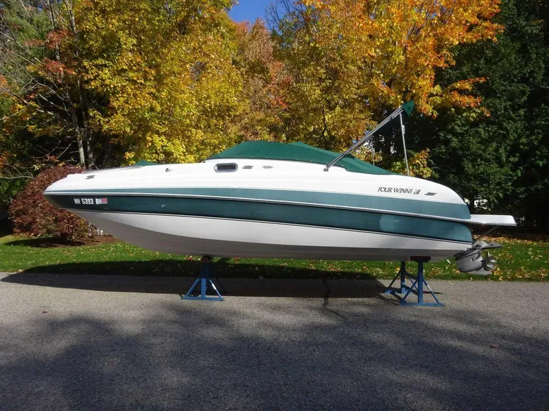 Slide: The Image of 2002 Four Winns 234 Funship boat on stands, surrounded by autumn trees. - 22