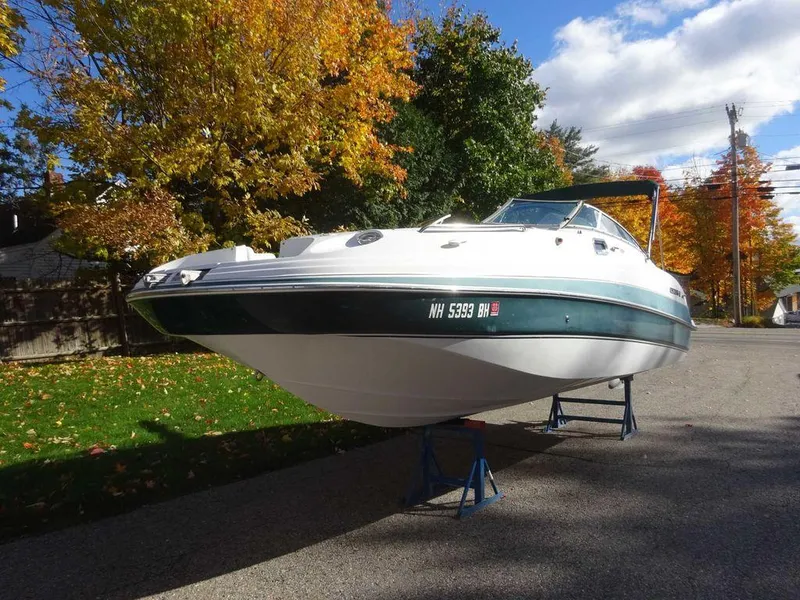 Slide: The Image of 2002 Four Winns 234 Funship boat on stands, autumn trees in background. - 5