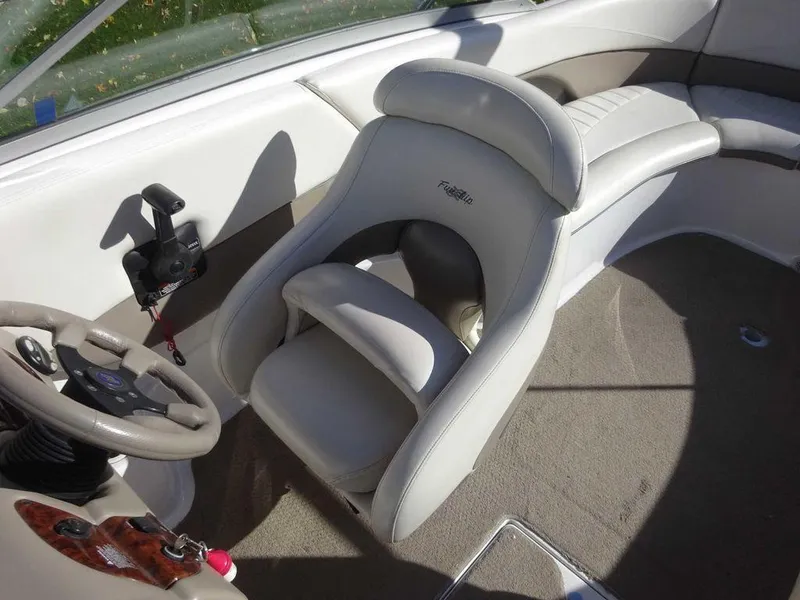 Slide: The Image of 2002 Four Winns 234 Funship boat interior with steering wheel and seating. - 6
