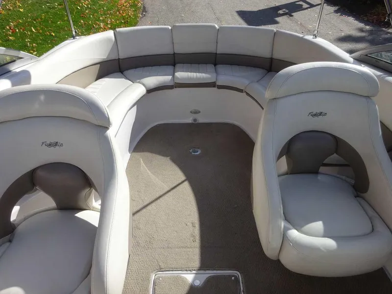 Slide: The Image of 2002 Four Winns 234 Funship boat interior with plush seating and carpeted floor. - 9