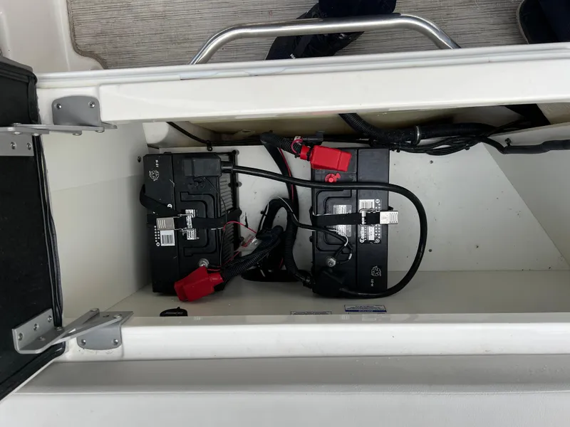 Slide: The Image of 2022 Sea Ray SDX 290 boat battery compartment with dual batteries. - 11