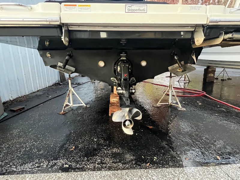 Slide: The Image of 2022 Sea Ray SDX 290 boat stern view with propeller and supports. - 13