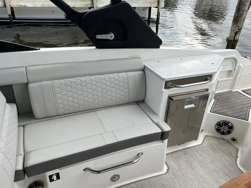 Slide: The Image of 2022 Sea Ray SDX 290 boat interior with cushioned seating and storage. - 4