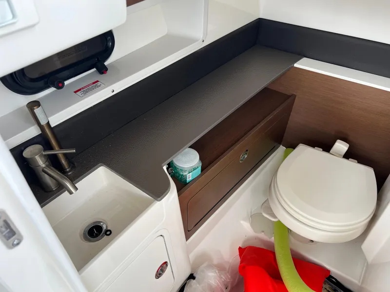 Slide: The Image of 2022 Sea Ray SDX 290 boat bathroom with sink and toilet. - 6