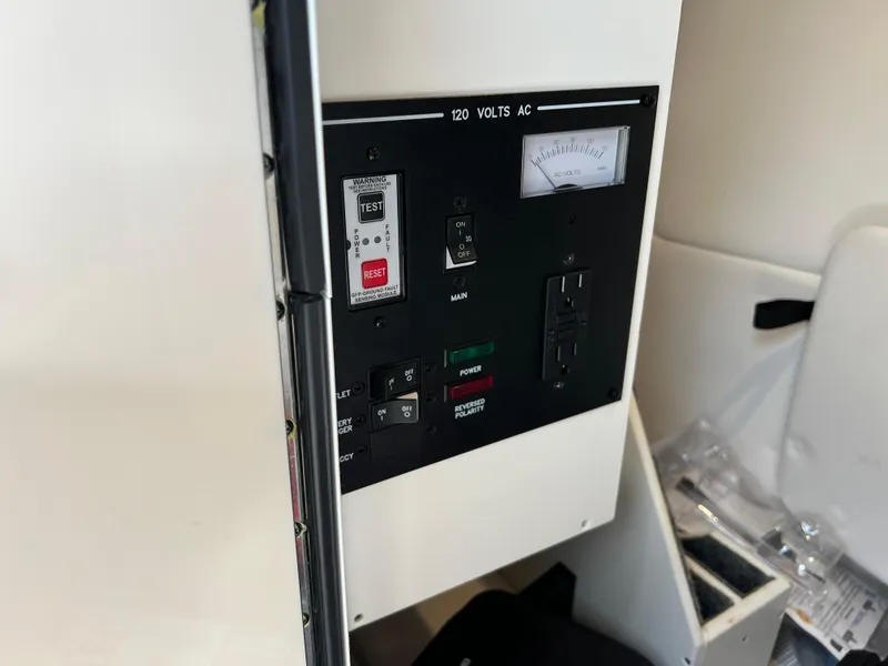 Slide: The Image of Electrical panel of 2022 Sea Ray SDX 290 boat, featuring voltage controls and switches. - 9