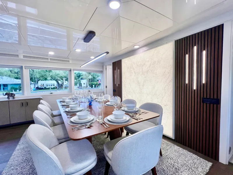 Slide: The Image of Luxurious dining area on 2011 Mengi Yay 115 MY yacht, featuring elegant table settings. - 42