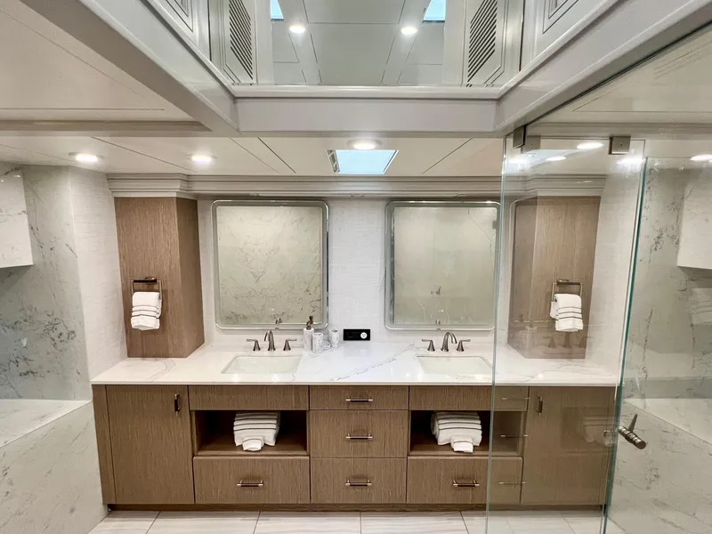Slide: The Image of Luxurious yacht bathroom with dual sinks, modern fixtures, and elegant wood cabinetry on Mengi Yay 115 MY. - 53