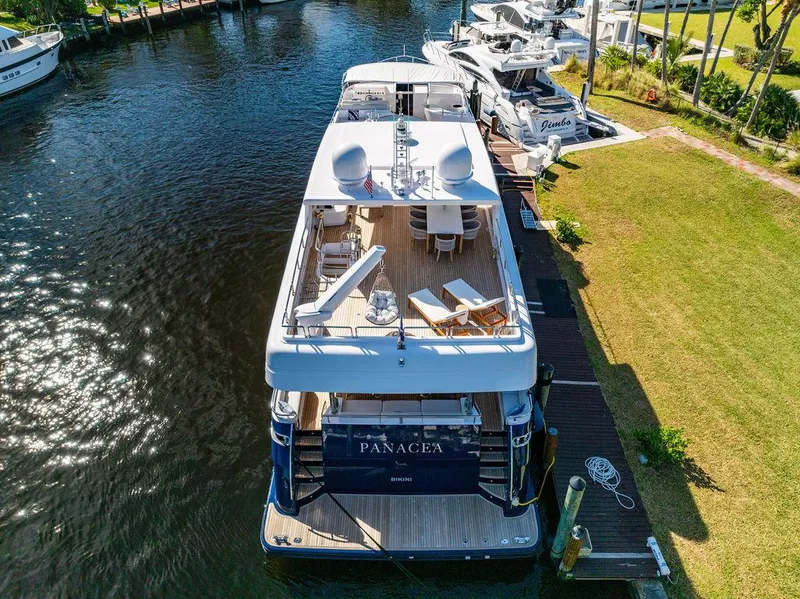 Slide: The Image of Luxury yacht Mengi Yay 115 MY, 2011, docked in a serene marina setting. - 7