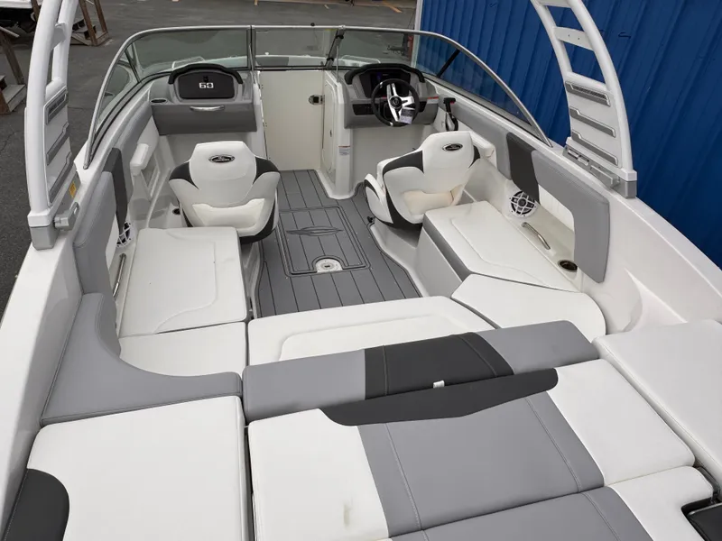 Slide: The Image of 2025 Chaparral 23 SSi OB boat interior with white and gray seating, modern design. - 30