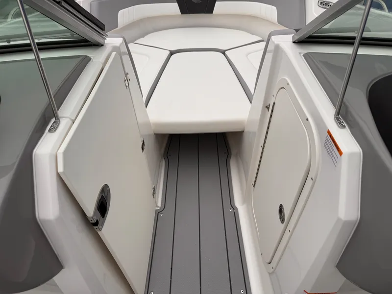 Slide: The Image of 2025 Chaparral 23 SSi OB boat interior with sleek seating and storage compartments. - 39