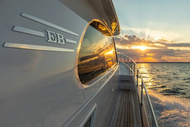 Slide: The Image of Eastbay EB60 yacht cruising at sunset, 2025 model, reflecting golden ocean views. - 6