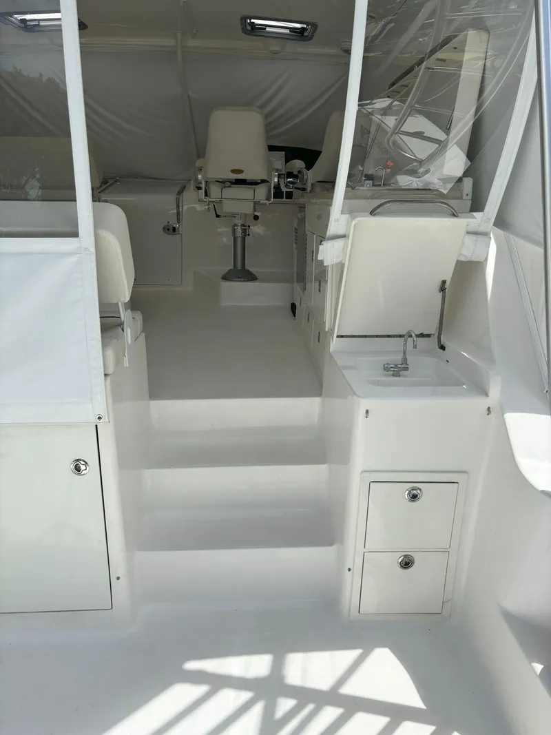 Slide: The Image of 2006 Luhrs 41 Open boat interior with helm chairs and storage compartments. - 12